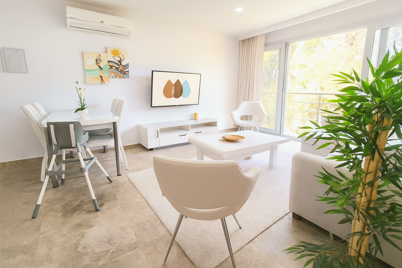 Dining area with high chair, lounge chair and floor-to-ceiling forest view