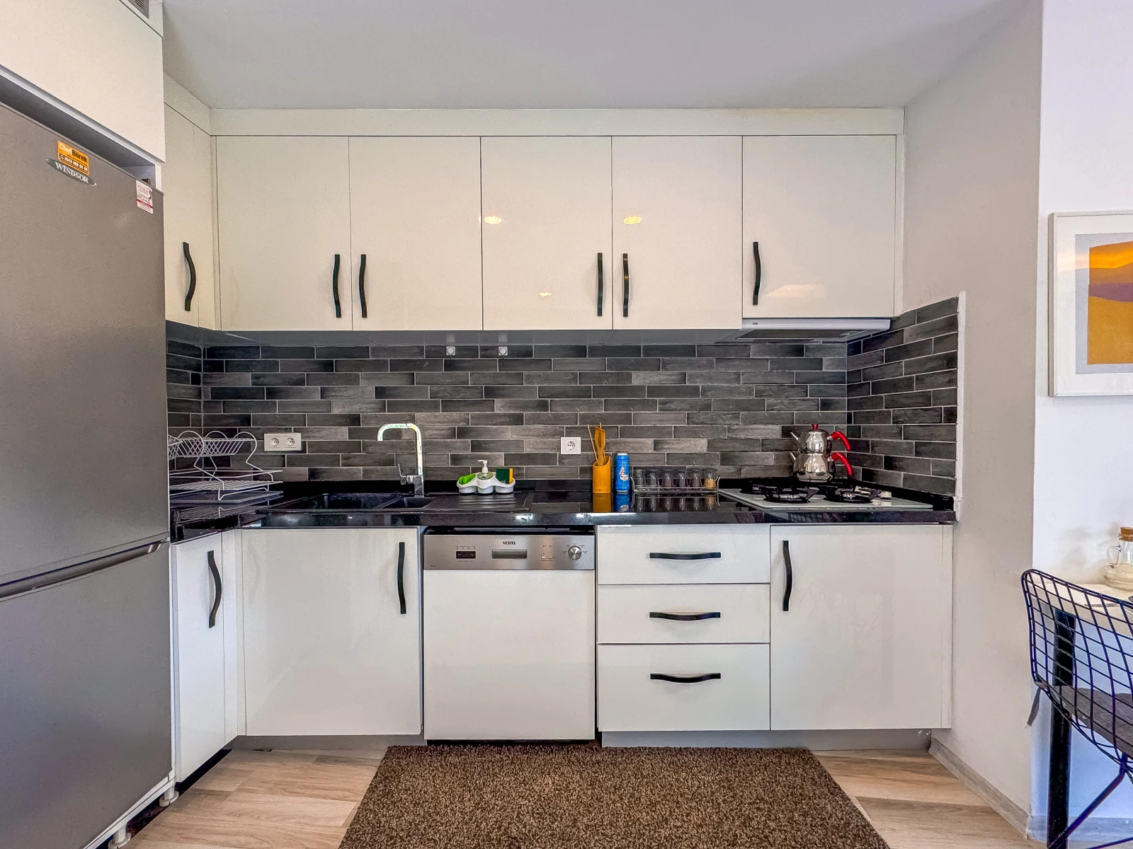 Modern kitchen with oven, microwave, dishwasher and coffee machine