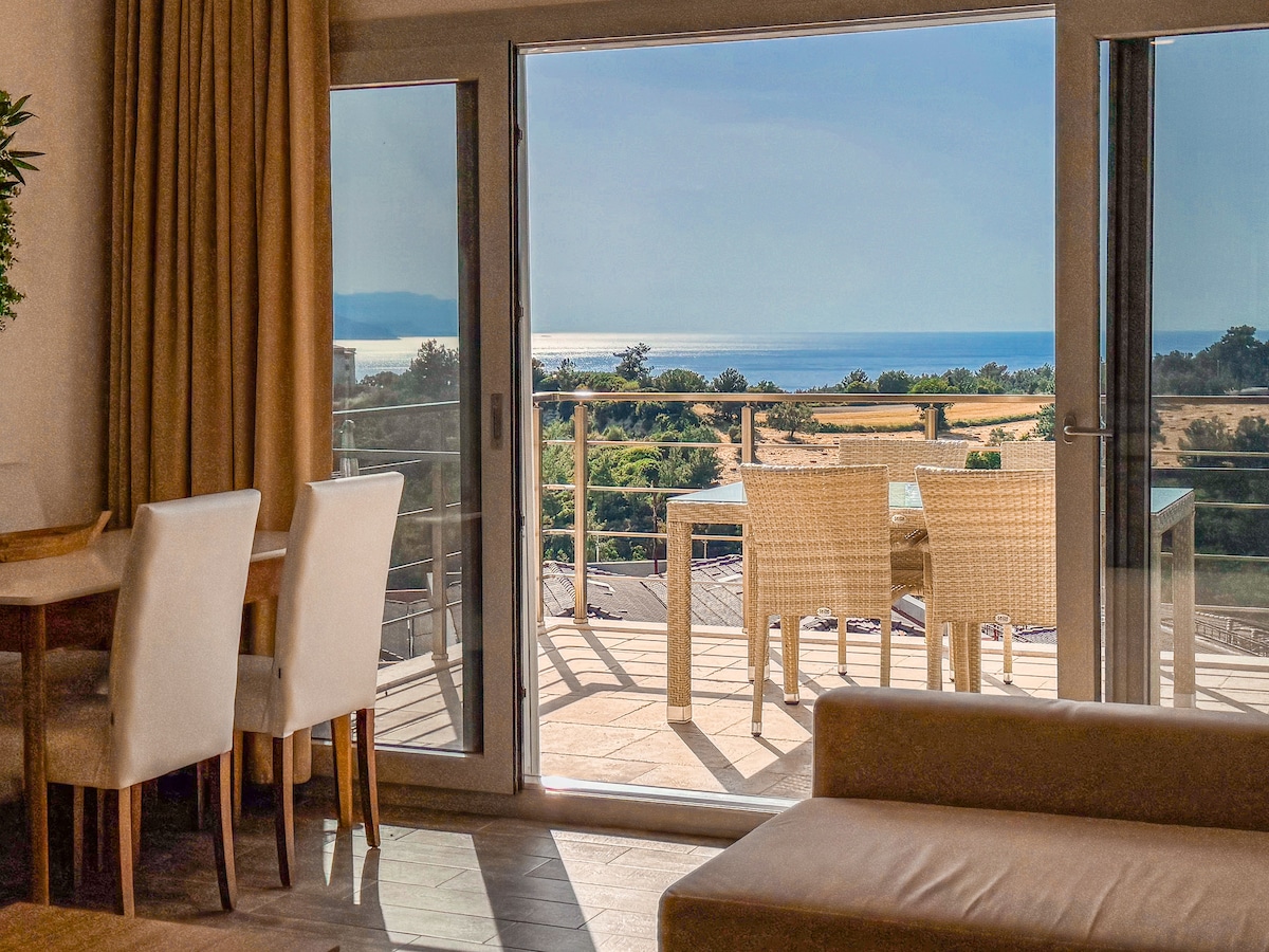Penthouse living and dining area with Aegean views