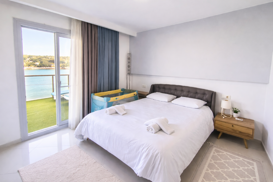 Master bedroom with king bed and sea-view balcony