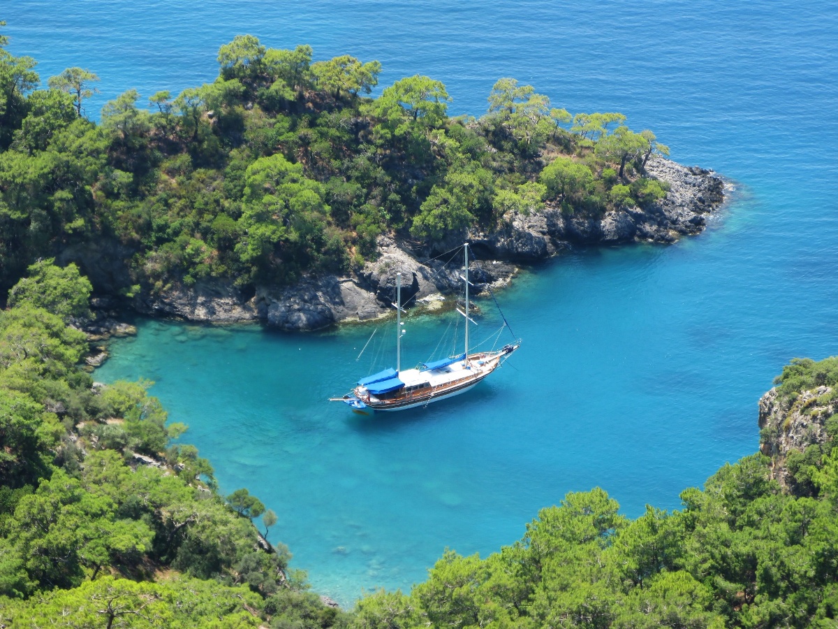 Turquoise cove with a wooden gulet inside Dilek Peninsula National Park