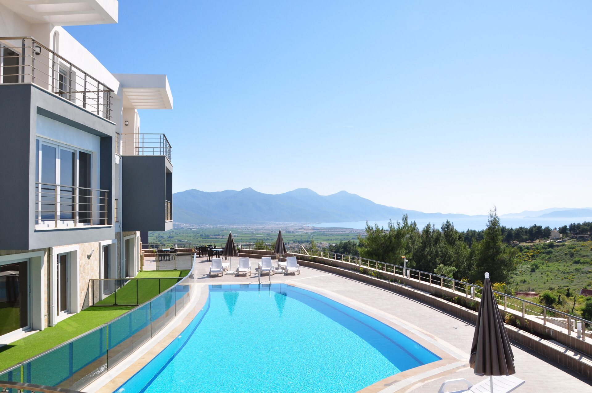 Pool terrace at Lavender Residence with sweeping view across the bay to the mountains
