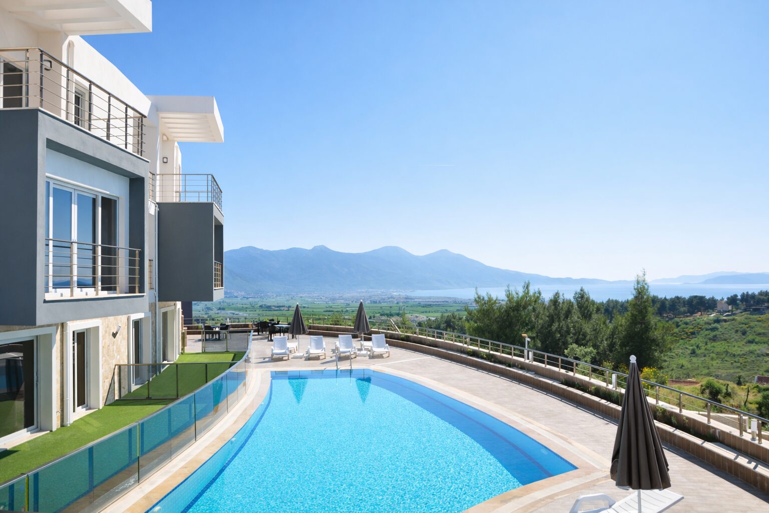 Lavender Residence curved outdoor pool with Aegean sea, mountains and pine valley panorama