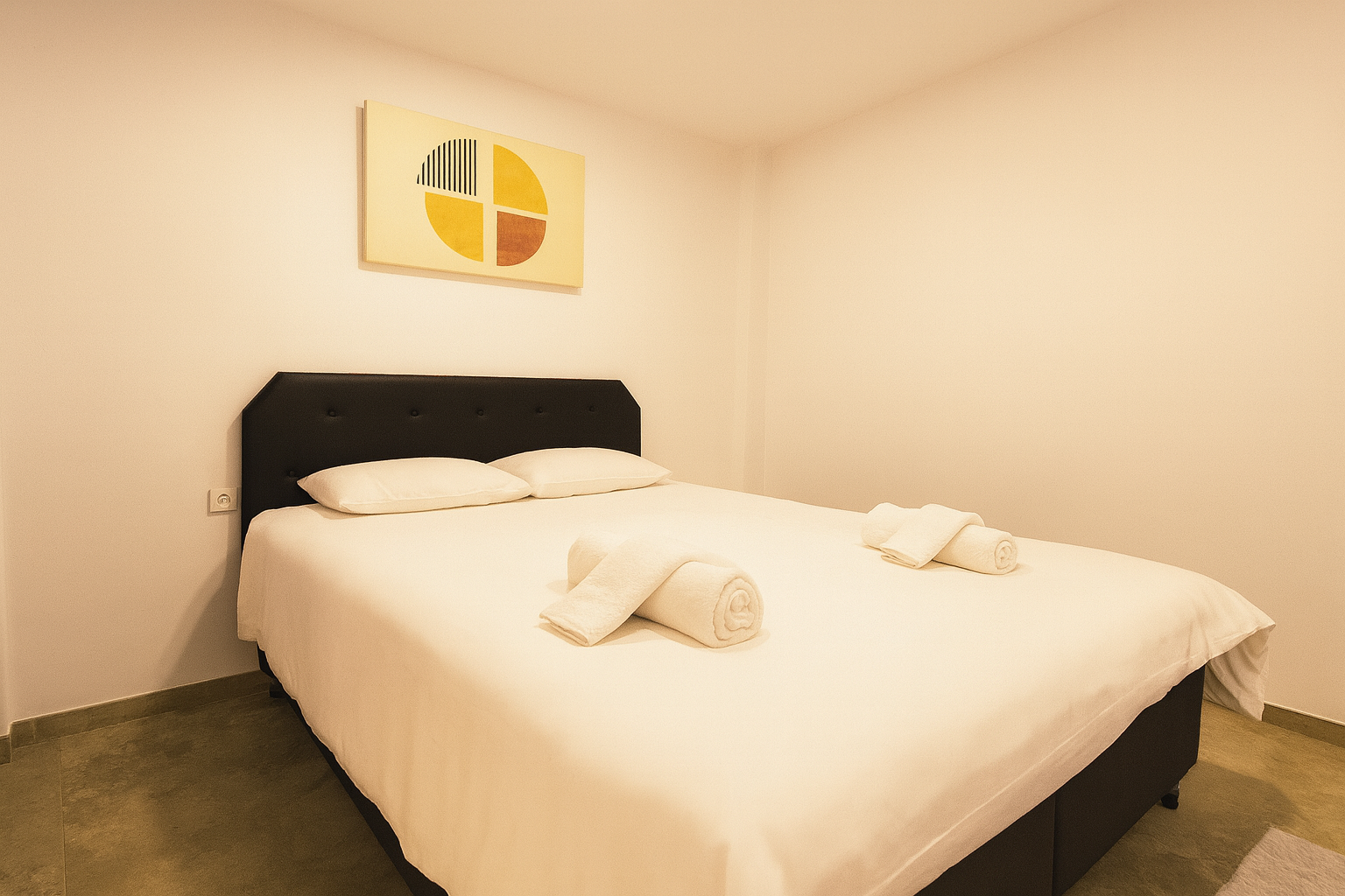 Second bedroom with double bed and minimalist artwork