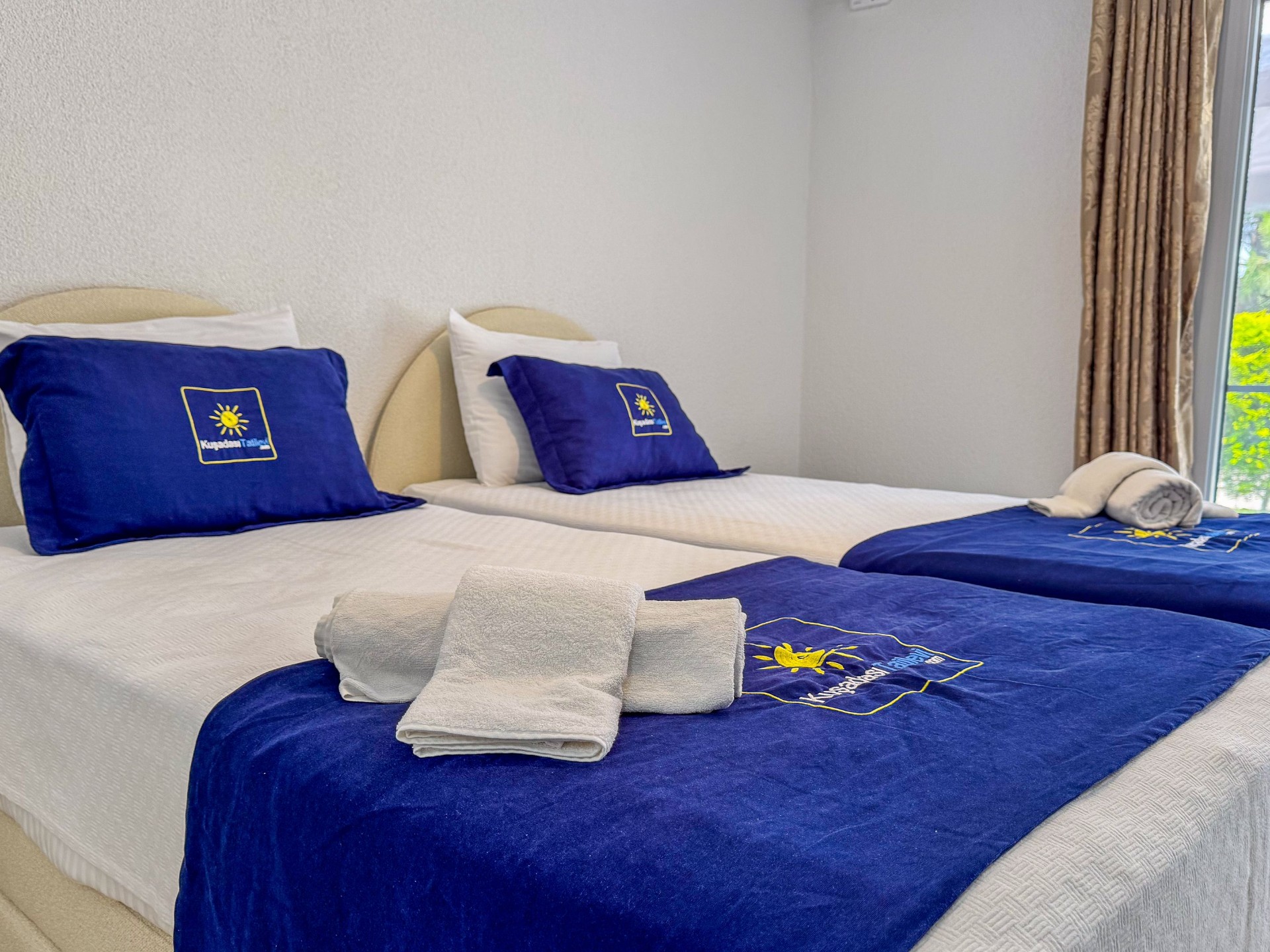 Twin bedroom close-up with neatly prepared single beds and towels