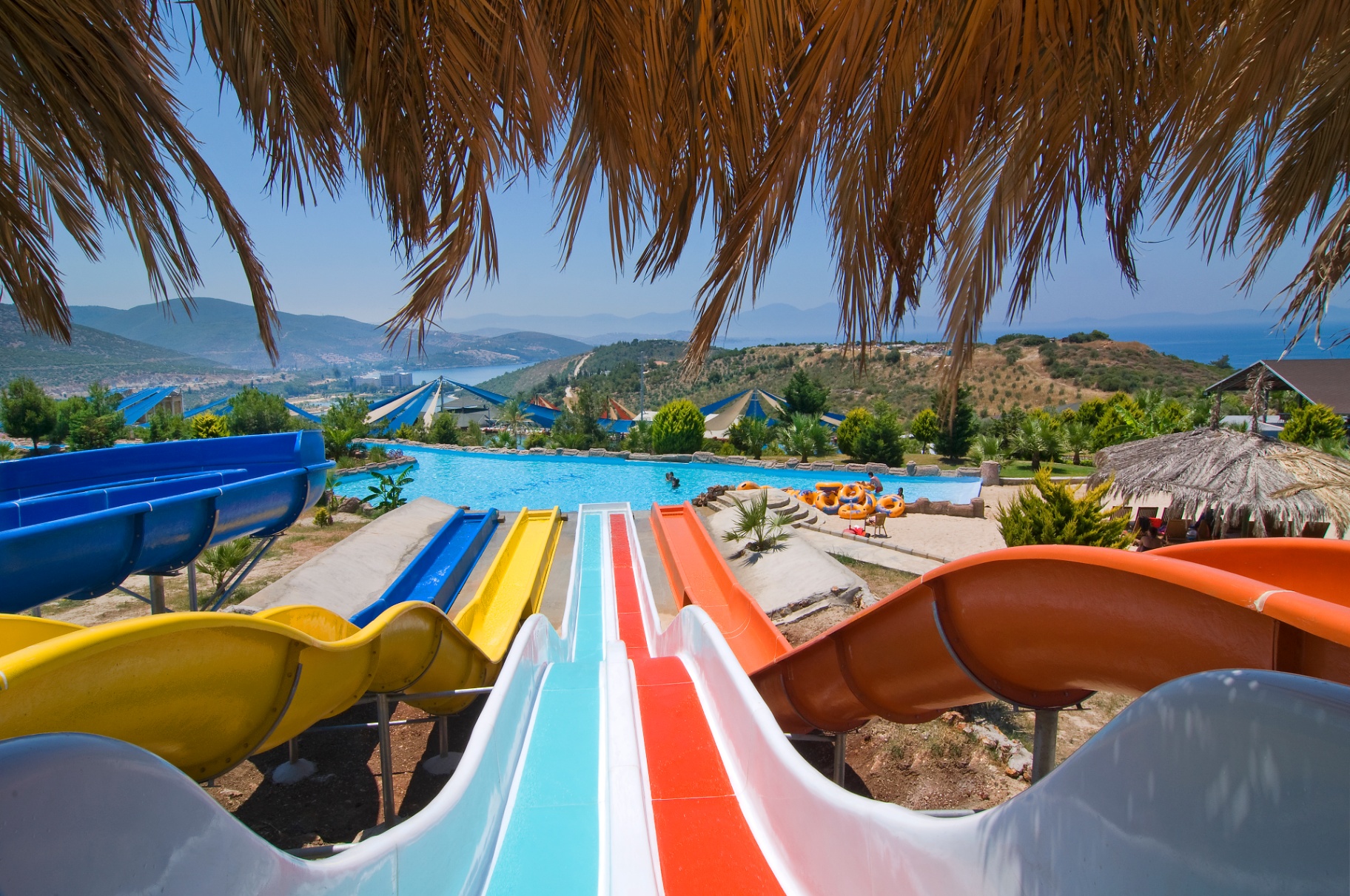 Colourful waterpark slides above a turquoise pool near Kuşadası